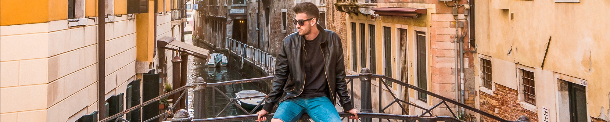 man sitting on bridge in Italy