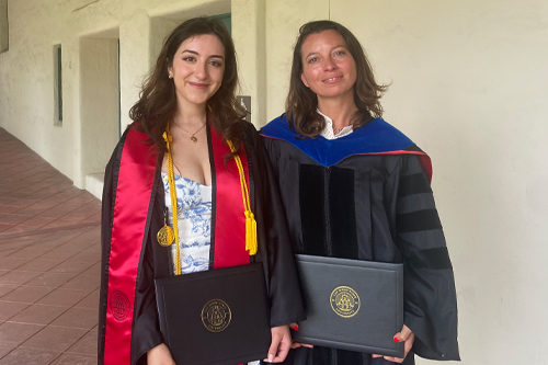two women in graduation regalia